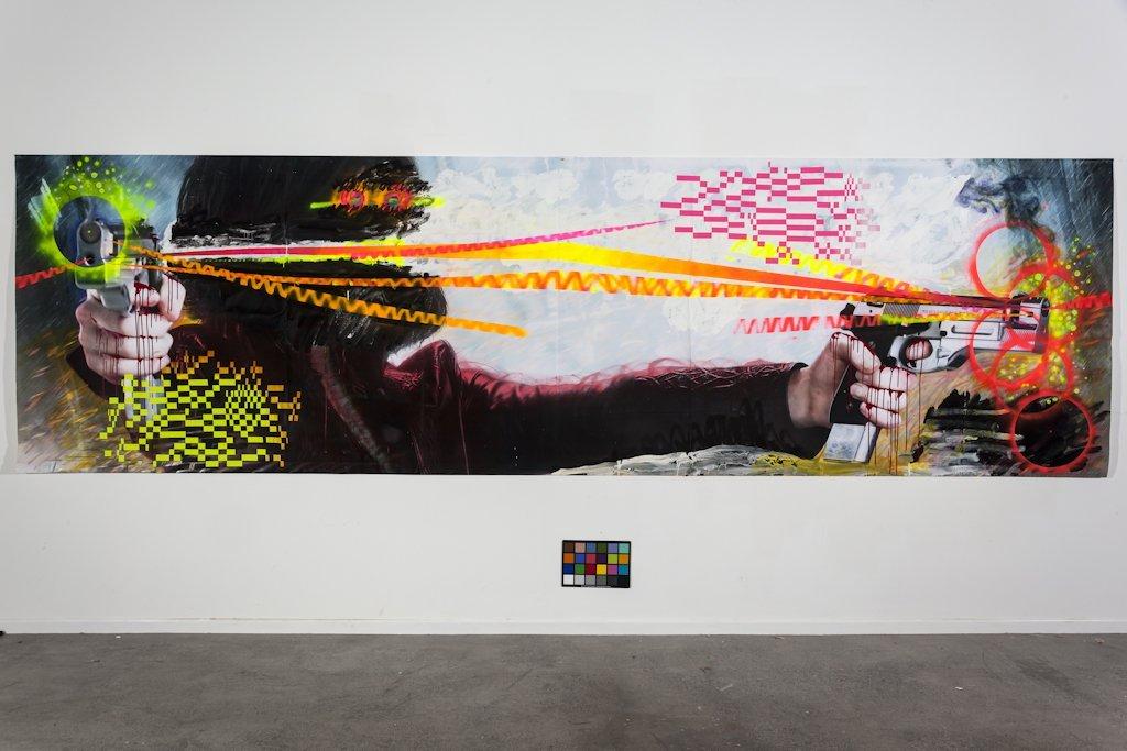 An installation view of a large scale painting in a gallery depicting to hands shooting guns